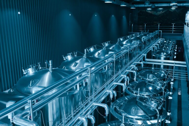 Private microbrewery. Modern beer plant with brewering kettles, tubes and tanks made